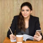 smiling female student doing homework desk 1262 5768